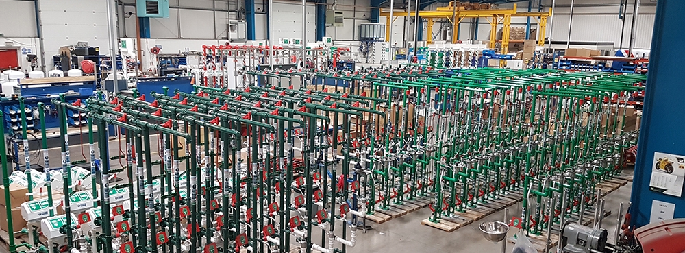 Elevated view of rows of Hughes safety showers from shop floor