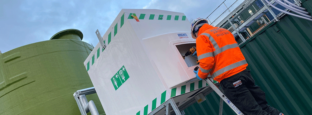 Engineer servicing a Hughes tank shower