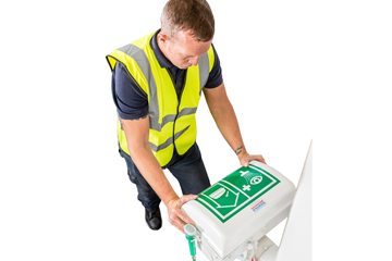 Male worker lifting eye wash lid