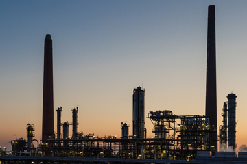Chemical processing plant shown in front of a sunset