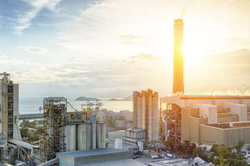 petrochemical plant with bright sunshine behind