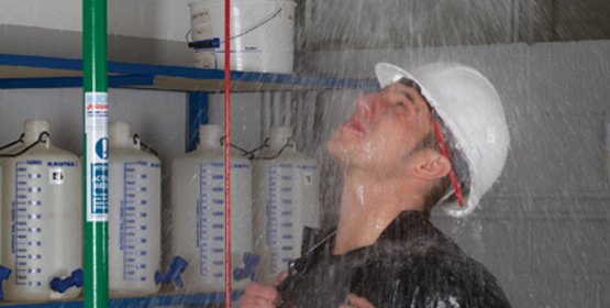 Worker using an indoor Hughes safety shower