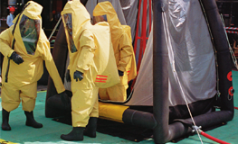 Hughes decontamination unit in use by workers in PPE
