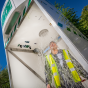 Worker using Hughes 1500L emergency tank shower 