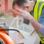 ABS closed bowl eye wash in use by worker as part of mobile unit hire