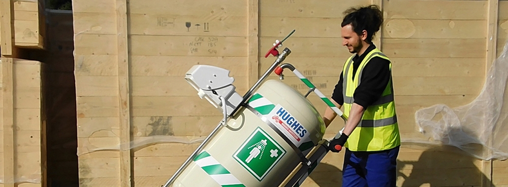 Worker transporting the Hughes 40K mobile safety shower