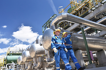 Oil and gas workers surveying pipelines