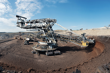 Mining excavator on worksite with blue sky in background