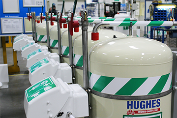 Several stock-ready Hughes mobile safety showers and eye washes lined up
